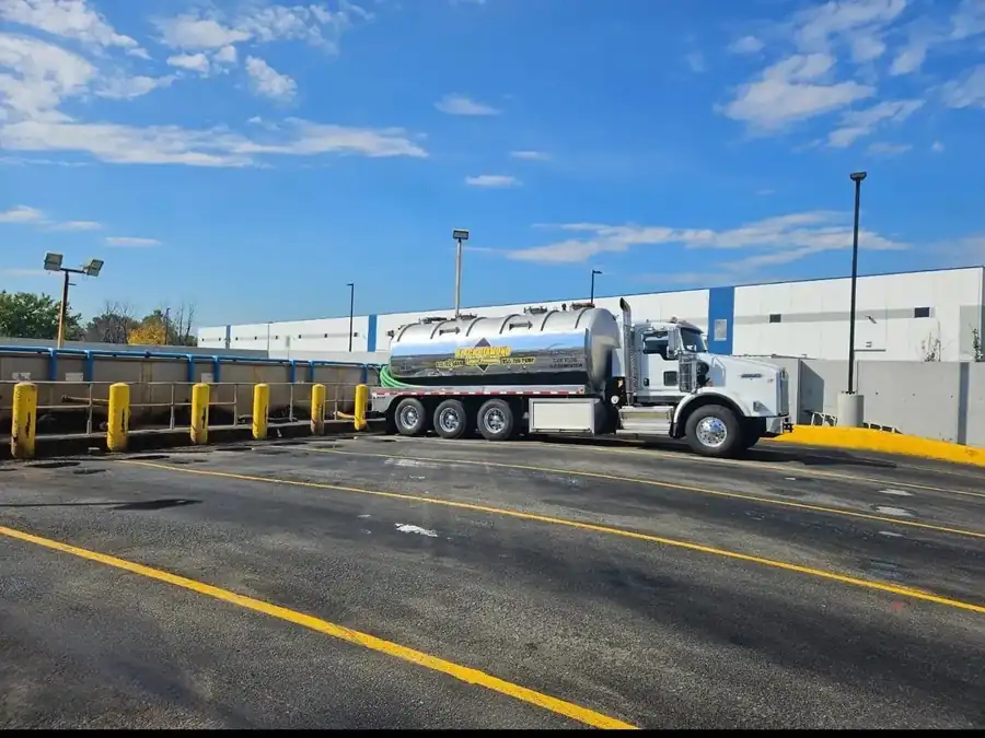 Black Diamond tanker truck parked at a commercial property for a scheduled pump-out