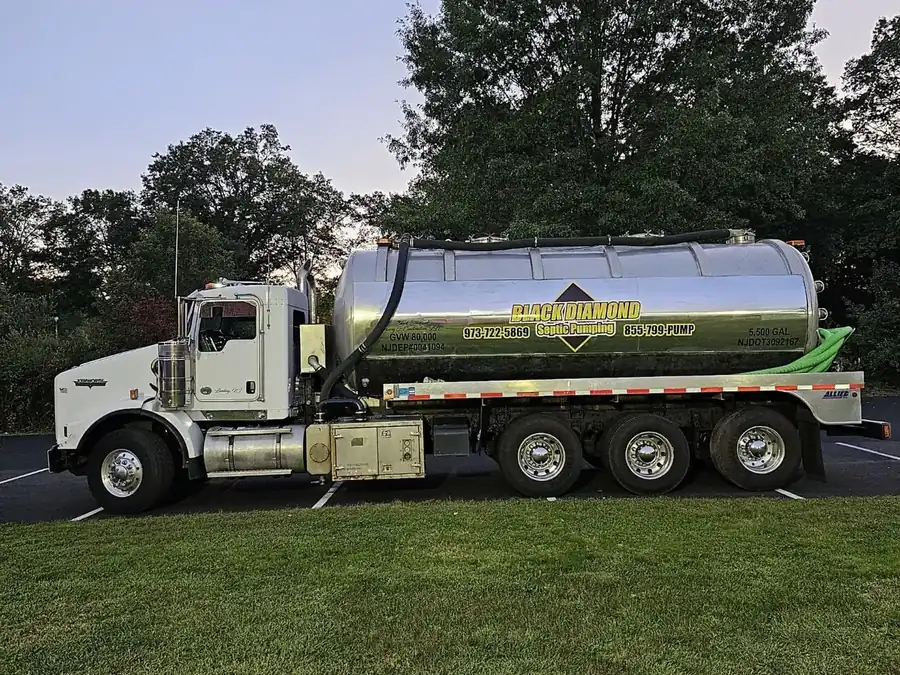 Black Diamond tanker truck parked on the grass at a residential job